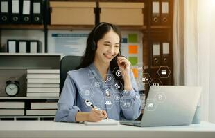 Asian business woman have the joy of talking on the smartphone, tablet and laptop video call on the modern office photo