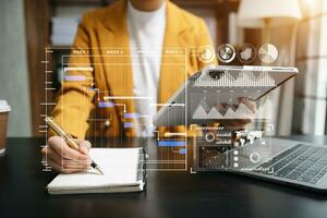 Businessman hand Project manager working and update tasks and Gantt chart scheduling virtual diagram.with smart phone, tablet and laptop photo