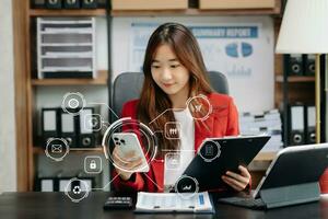 Businesswoman working with smart phone and laptop and digital tablet computer in office with digital marketing media in virtual icon photo