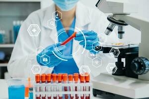 DNA molecule testing concepts. The doctor in a mask examines DNA molecules on the chemical laboratory with virtual icon photo