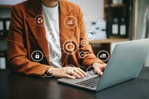 Businesswoman hand using laptop, tablet and smartphone  in office. Digital marketing media mobile app in virtual icon photo