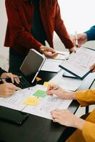 Close up view of UI developer team brainstorming on their project with laptop, smartphone and digital tablet. Creative digital development agency. with virtual icon photo