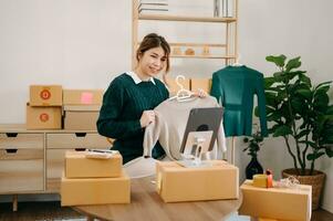 Starting small businesses SME owners, woman check online orders Selling products working with boxs freelance work at home office using tablet and laptop packaging, concept photo