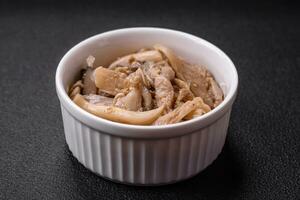 Delicious spicy mushrooms sliced and cooked in Korean style on a ceramic plate photo