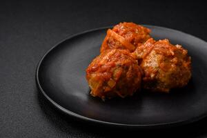 Delicious fresh meatballs from minced meat or fish with tomato sauce photo