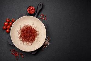 Red thin hot chili threads on a dark background photo