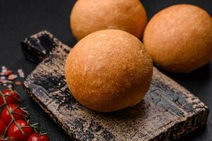 Delicious fresh crispy white round bread with seeds and grains photo