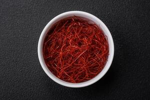 Red thin hot chili threads on a dark background photo