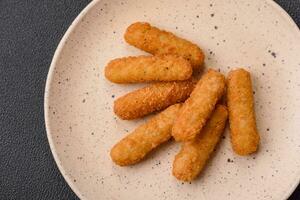 Delicious crispy cheese sticks with mozzarella, salt and spices, breaded photo