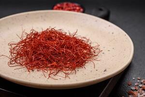 Red thin hot chili threads on a dark background photo