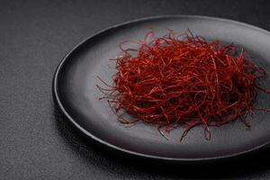 Red thin hot chili threads on a dark background photo