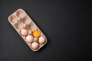 Raw chicken eggs in a box, cherry tomatoes, chickpeas, spices, salt and herbs photo