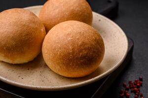 Delicious fresh crispy white round bread with seeds and grains photo