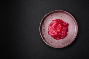 Delicious spicy pink cabbage sliced and cooked in Korean style on a ceramic plate photo