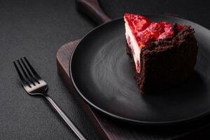 Beautiful tasty sweet slice of cheesecake with cherry on a ceramic plate photo