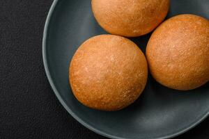 Delicious fresh crispy white round bread with seeds and grains photo