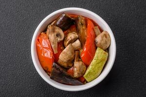 Delicious salad of grilled vegetables tomatoes, mushrooms, sweet peppers, eggplants photo