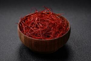 Red thin hot chili threads on a dark background photo