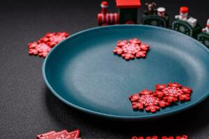 Ceramic round plate decorated with festive elements on the Christmas table photo