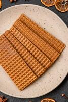 Delicious sweet crispy rectangular waffles on a ceramic plate photo