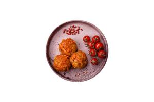 Delicious fresh meatballs from minced meat or fish with tomato sauce photo