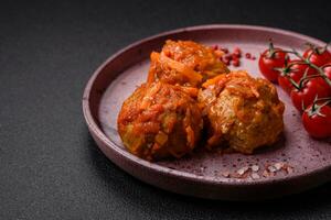 Delicious fresh meatballs from minced meat or fish with tomato sauce photo