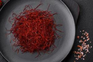 Red thin hot chili threads on a dark background photo