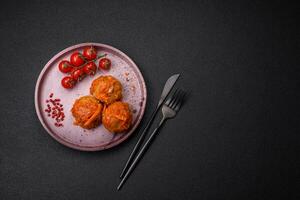 Delicious fresh meatballs from minced meat or fish with tomato sauce photo