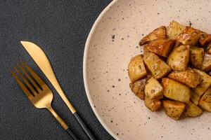 Delicious crispy fried potato wedges with salt, spices and herbs photo