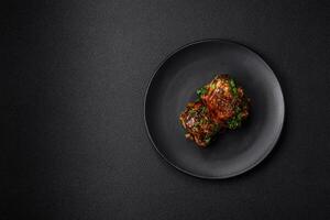 Delicious juicy fried chicken in teriyaki sauce with salt, spices, herbs and sesame seeds photo