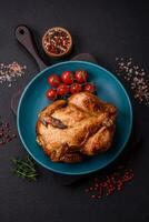 Crispy delicious whole baked chicken with vegetables, salt and spices photo