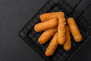 Delicious crispy cheese sticks with mozzarella, salt and spices, breaded photo