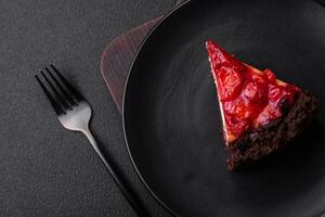 Beautiful tasty sweet slice of cheesecake with cherry on a ceramic plate photo