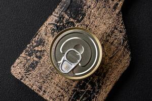 Round metal can with canned fish or meat with a key photo