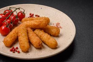 Delicious crispy cheese sticks with mozzarella, salt and spices, breaded photo