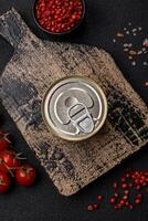 Round metal can with canned fish or meat with a key photo