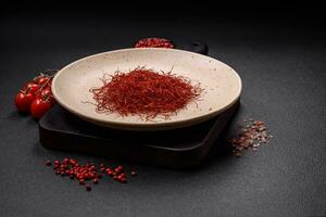 Red thin hot chili threads on a dark background photo