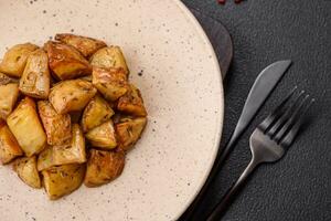 Delicious crispy fried potato wedges with salt, spices and herbs photo