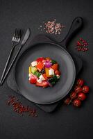 Delicious juicy Greek salad with feta cheese, olives, cucumber and tomatoes photo