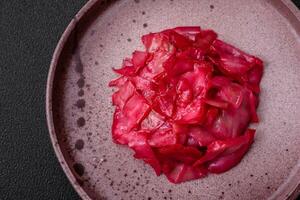 Delicious spicy pink cabbage sliced and cooked in Korean style on a ceramic plate photo