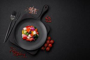 Delicious juicy Greek salad with feta cheese, olives, cucumber and tomatoes photo