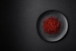 Red thin hot chili threads on a dark background photo