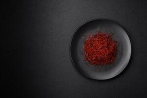 Red thin hot chili threads on a dark background photo