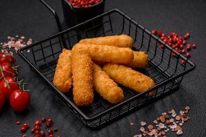 Delicious crispy cheese sticks with mozzarella, salt and spices, breaded photo