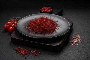 Red thin hot chili threads on a dark background photo