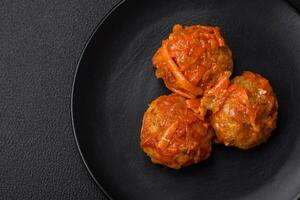 Delicious fresh meatballs from minced meat or fish with tomato sauce photo