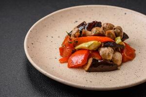 Delicious salad of grilled vegetables tomatoes, mushrooms, sweet peppers, eggplants photo