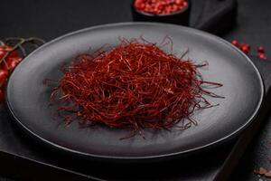 Red thin hot chili threads on a dark background photo