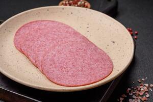 Delicious smoked salami sausage with salt, spices and herbs photo