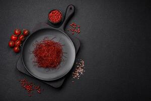 Red thin hot chili threads on a dark background photo